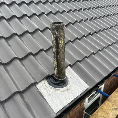 New roof installation project in Merseyside showing completed tiled roof with new ridge tiles