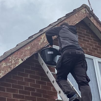 Roof repair work showing damaged tiles replaced and secured in Merseyside