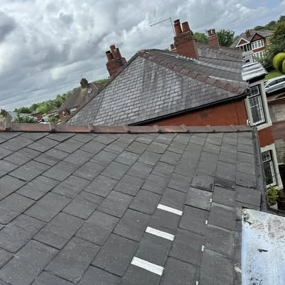 Storm damage roof repair showing missing tiles replaced in Warrington